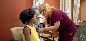 Pediatric LPN performs a physical examination on a patient